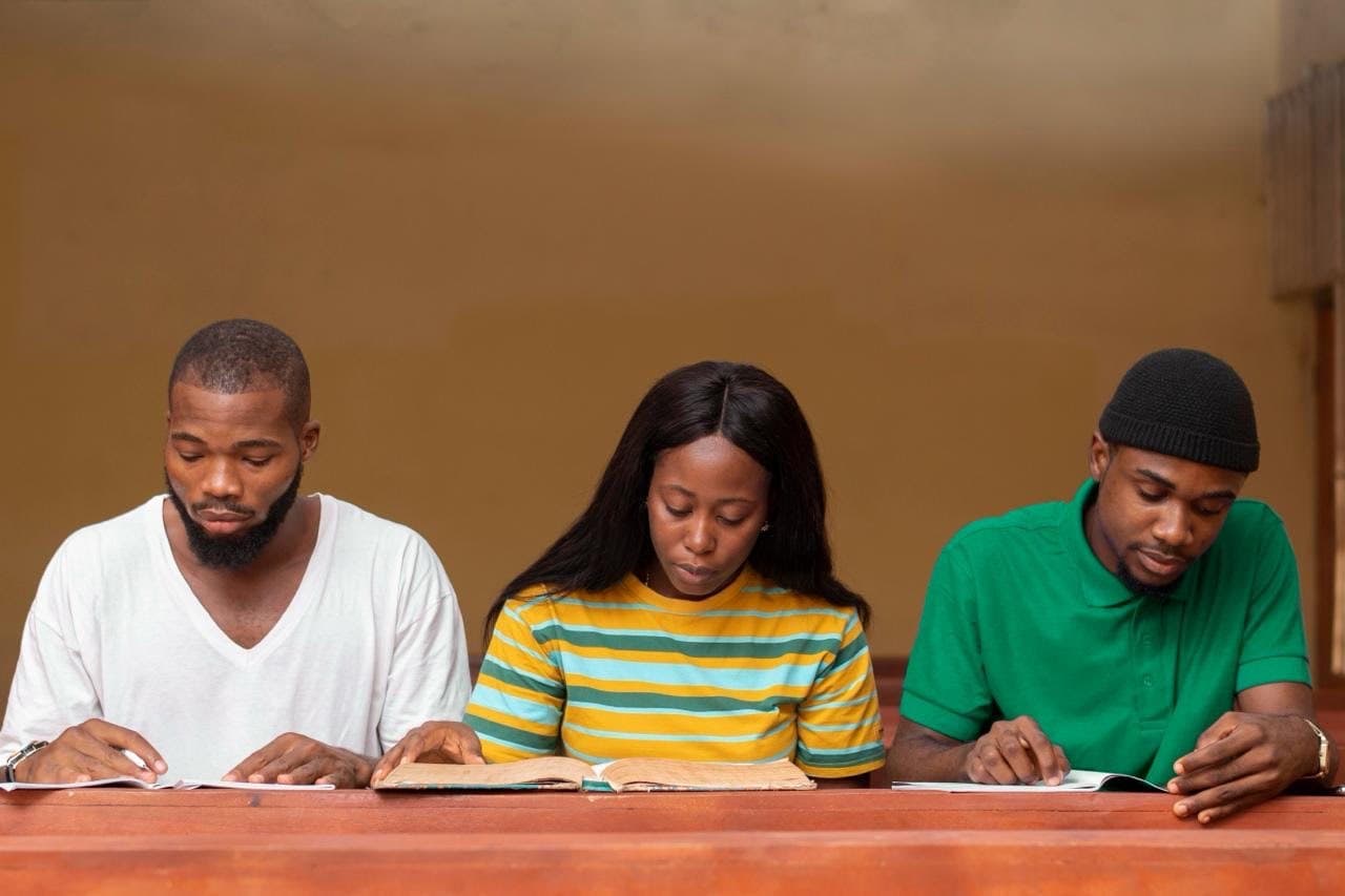 Students sitting an assessment at a classroom desk